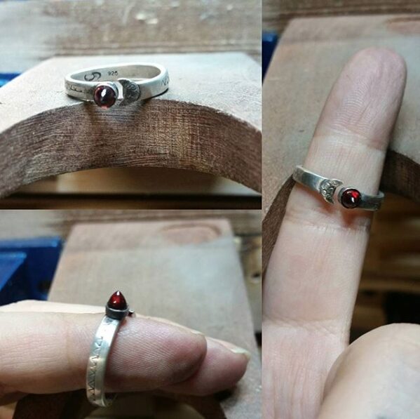 A trio of photos of a sterling silver wrap ring with an inset bullet-shaped garnet.